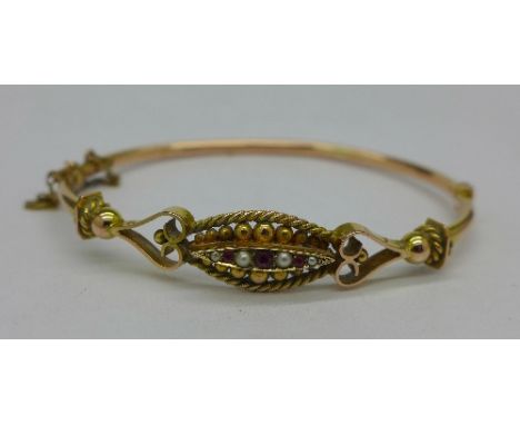 A 9ct gold, pearl and ruby bangle, 6.3g