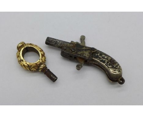 A novelty 19th Century watch key in the form of a pistol with silver grip depicting a hunting scene and a yellow metal watch 