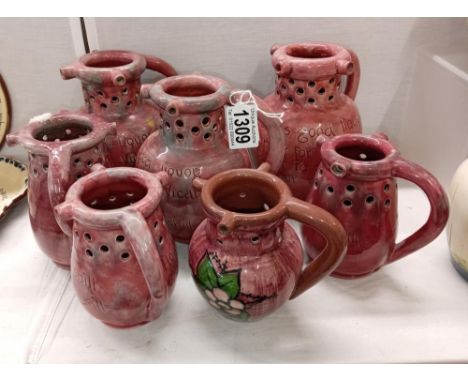 7 pink glazed Barum Barnstaple pottery puzzle jugs