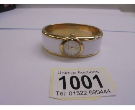 A Caravelle New York white enamel bangle watch, in working order.