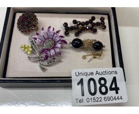 Three 19th century garnet set brooches. one with heart to front and safety, together with enamel &amp; marquisate flower broo