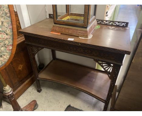 A carved mahogany hall table with bottom shelf