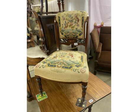 A vintage tapestry covered nursing chair