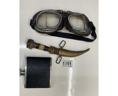 A pair of Antique goggles a leather whiskey flask and a knife