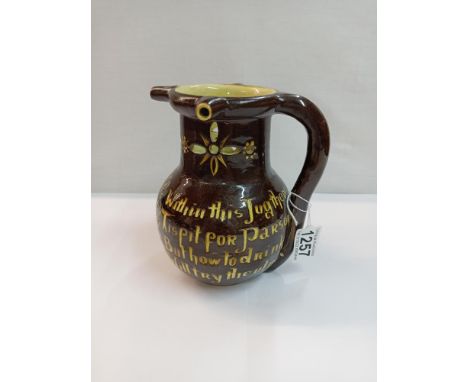 C H Brannam barum pottery puzzle jug. Height 17.5cmCrazing to glaze, no visible damage.