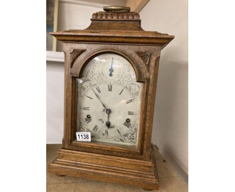 An oak cased mantel clock with silvered dial, COLLECT ONLY.