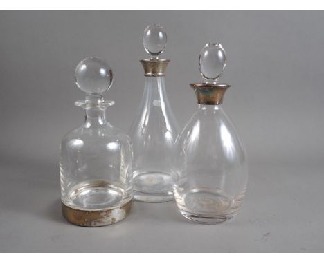 Two glass decanters with silver collars and a Links of London glass decanter with silver base 