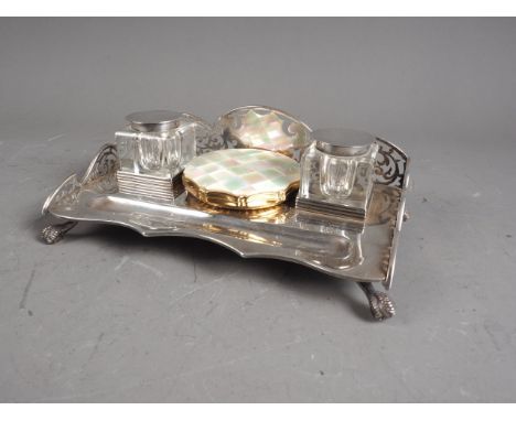 An Edwardian silver desk stand with pierced gallery and two silver mounted square glass inkwells, raised on ball and claw fee