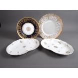 A Royal Doulton bone china gilt decorated cabinet plate, 9" dia, a larger similar plate and a pair