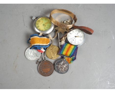 Two WWI medals, awarded to 159355 Gunner G E Gifkins, a cap badge, two commemorative medals, two pocket watches and a rolled 