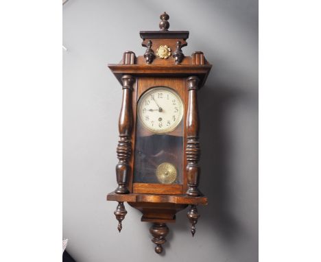 An early 20th century walnut cased eight-day wall clock, 27" high,&nbsp;an Edwardian mahogany and brass inlaid mantel clock w