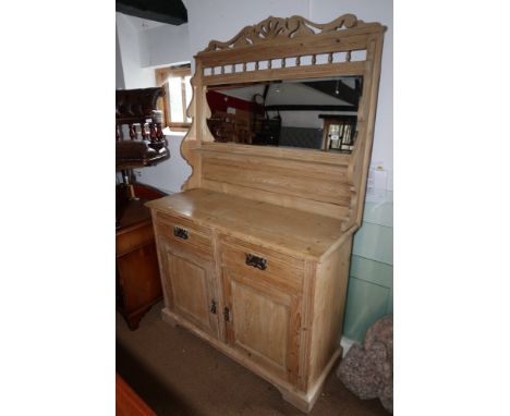 A late 19th century stripped pine dresser/sideboard with raised mirror back, fitted shelf over two drawers and cupboards, on 