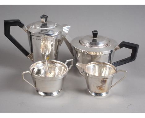 An Art Deco four-piece silver teaset with ebonised knops and handles, a pair of bright cut silver sugar tongs and a silver te