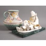 An H J Wood Art Deco floral relief decorated jug, 8 1/2" high, and a studio porcelain "Commedia"