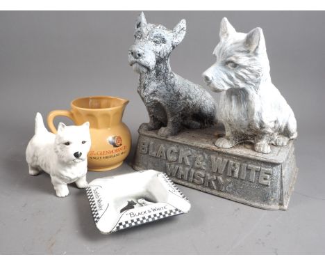 A "Black &amp; White" whisky advertising model, 10" high, a matching ashtray, a white Highland terrier model and a "Glenmoran