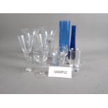 A set of nine clear glass goblets, a smaller matching set of six goblets, three tumblers, three blue