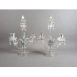 A pair of 19th century cut glass two-light candlesticks, on circular bases, 19" high