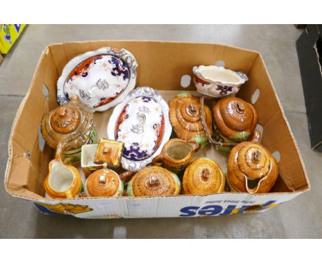 A box of cottageware; teapots, jugs, biscuit barrel, two Staffordshire tureens, one repaired and a sugar basin or small turee