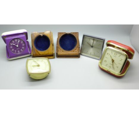 Two carved wood watch holders and vintage travel clocks 