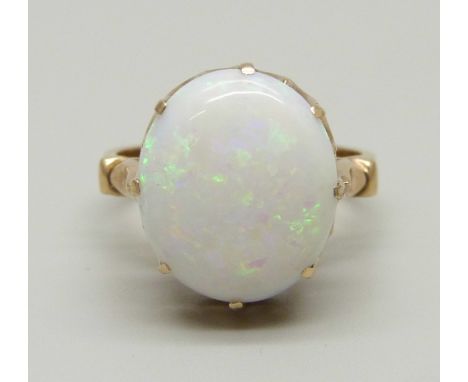 A yellow metal ring set with an opal in a claw setting, tests as gold, marked 14 on the outside of the shank, 3g, H 