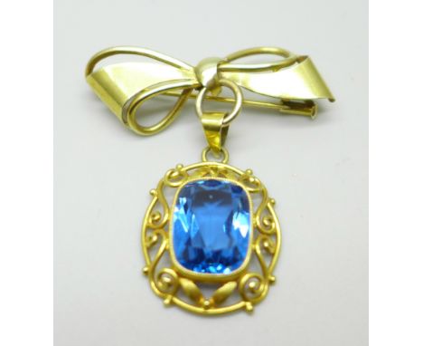 An 18ct gold pendant set with a blue stone, on a yellow metal brooch mount in the form of a bow, 6.7g 