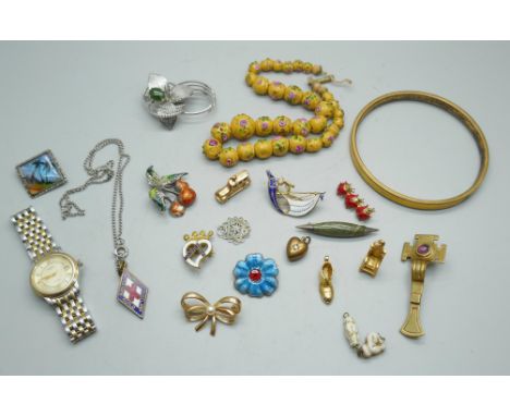 A gold colour bangle, a lady's Rotary watch and a collection of brooches, charms, etc. 