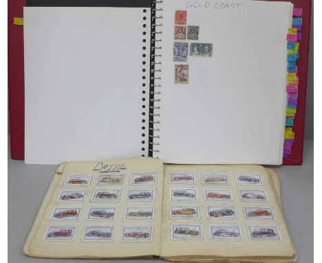 A stamp album containing world stamps, a collection of vintage comic postcards and a notebook containing Carl Anderson cards,