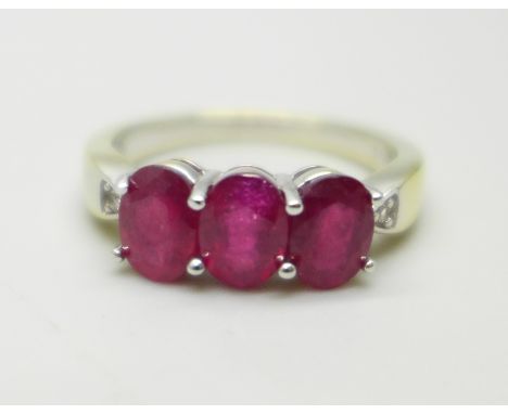 A silver gilt, ruby and white stone ring, S 