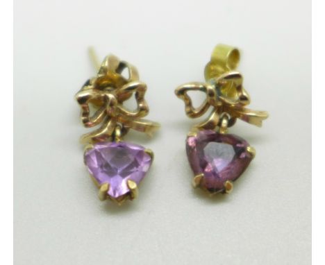 A pair of yellow metal earrings with bow detail, set with amethyst heart shape stones, 2.1g 