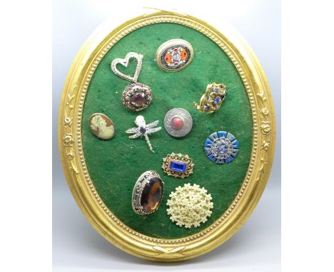 Eleven vintage costume brooches on stand 