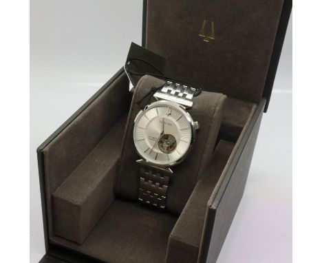 BULOVA: gents automatic 24 jewel wristwatch with skeleton movement on a stainless steel bracelet, boxed, working at lotting. 