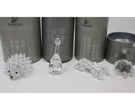 Four Swarovski miniatures, hedgehog, car, lute and a turtle, all boxed. UK P&amp;P Group 2 (£20+VAT for the first lot and £4+