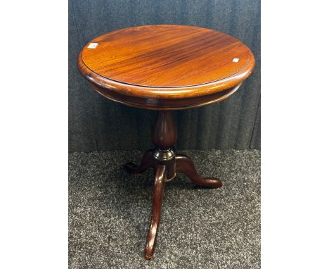 Reproduction mahogany Victorian style occasional table, The circular surface above a baluster column raised on a tripod base.