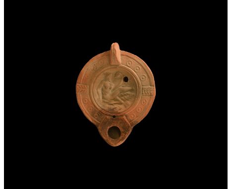 19th century AD. An antique or earlier Roman ceramic oil lamp in 2nd-3rd century AD style with short nozzle, lug handle to th