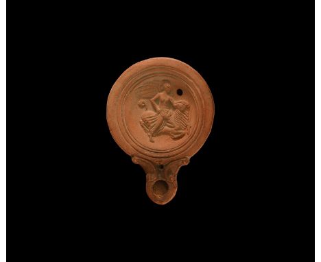 19th century AD. An antique or earlier Roman ceramic oil lamp in 2nd century AD style with round nozzle, volute scroll to eac