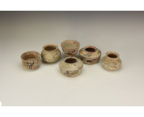 A mixed group of undated archaistic ceramic vessels with painted ornament of bovines, plants and various symbols.  1197 grams