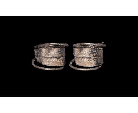 10th-12th century AD. A sheet silver finger ring with median hoop extending to two round-section bars coiled to the edges of 