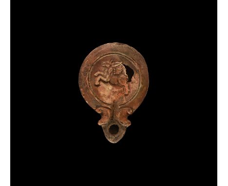 19th century AD. An antique or earlier Roman ceramic oil lamp in 1st-2nd century AD style with angled nozzle, volute scroll t