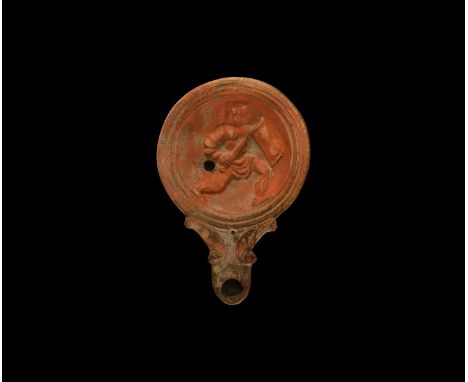 19th century AD. An antique or earlier Roman ceramic oil lamp in 2nd-3rd century AD style with long, rounded nozzle, volute s