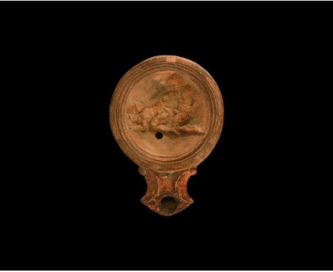 19th century AD. An antique or earlier Roman ceramic oil lamp in 1st-2nd century AD style with angled nozzle, volute scroll t