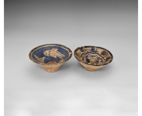 A group of two undated archaistic glazed ceramic bowls, one with two fish and central roundel, the other with rosettes and bo