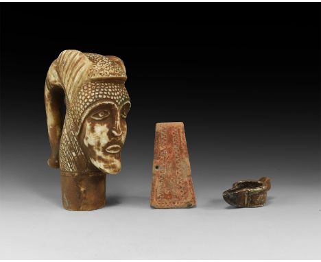 A mixed group of undated archaistic stone carvings comprising: a head with elephant-head detailing to the reverse; a conical 