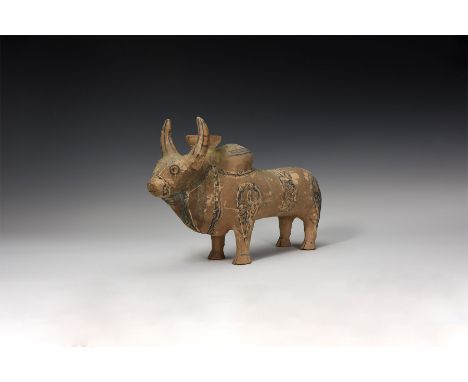 An undated archaistic hollow-formed ceramic zeby figurine with bands of painted detailing, cup to the neck between the horns.