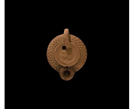 19th century AD. An antique or earlier Roman ceramic oil lamp in 3rd century AD style with rounded nozzle, lug handle to the 
