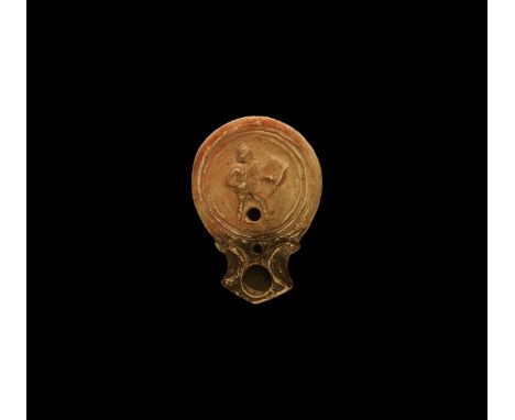 19th century AD. An antique or earlier Roman ceramic oil lamp in 1st century AD style with wide, angled nozzle and volute scr