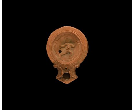 19th century AD. An antique or earlier Roman ceramic oil lamp in 1st century AD style with basal disc, volute scroll nozzle, 