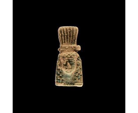 An undated archaistic glazed composition amulet formed as a facing female portrait in Third Intermediate Period, 1069-702 BC 