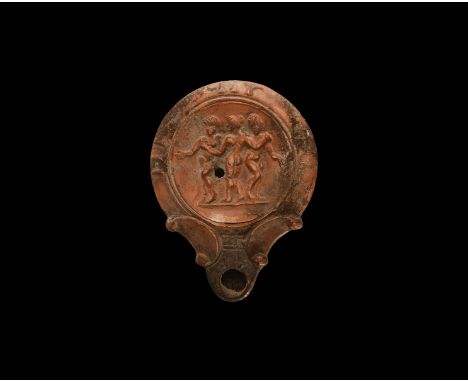 19th century AD. An antique or earlier Roman ceramic oil lamp in 2nd-3rd century AD style with round nozzle, volute scroll to