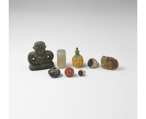 A mixed group of undated archaistic artefacts including an agate cylinder seal, a stone figure, a finger ring, a spindle whor