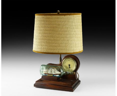 Later 20th century AD. A desk lamp unit comprising: wooden stand with two shallow depressions and stepped rim; round clock-fa